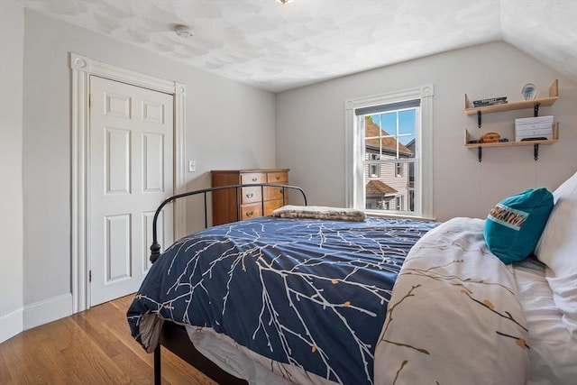 bedroom featuring baseboards and wood finished floors