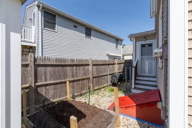 view of yard with fence and entry steps