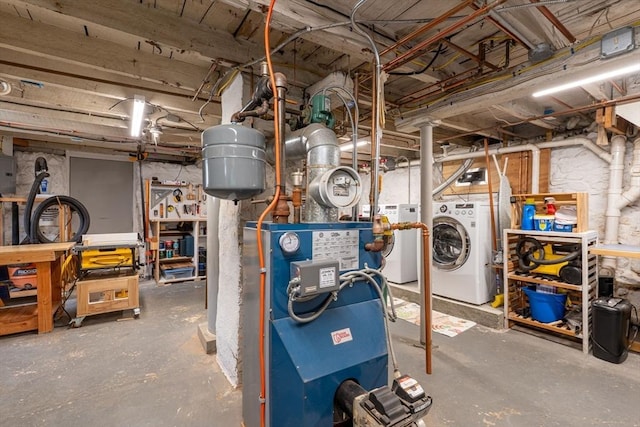 unfinished basement with a heating unit and independent washer and dryer