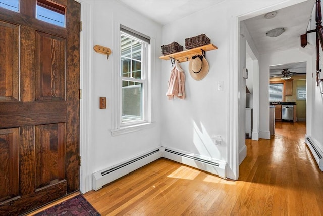 entryway with baseboards, a baseboard radiator, light wood finished floors, and ceiling fan