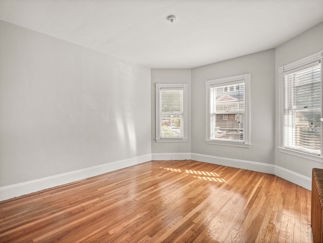 unfurnished room with light hardwood / wood-style floors and a healthy amount of sunlight