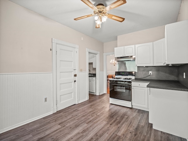 kitchen featuring white cabinets, ceiling fan, white range with gas stovetop, and dark hardwood / wood-style flooring