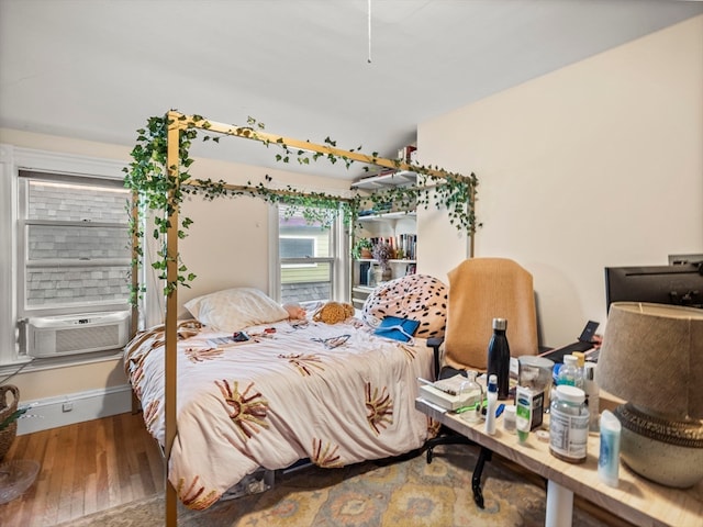 bedroom featuring cooling unit and hardwood / wood-style floors