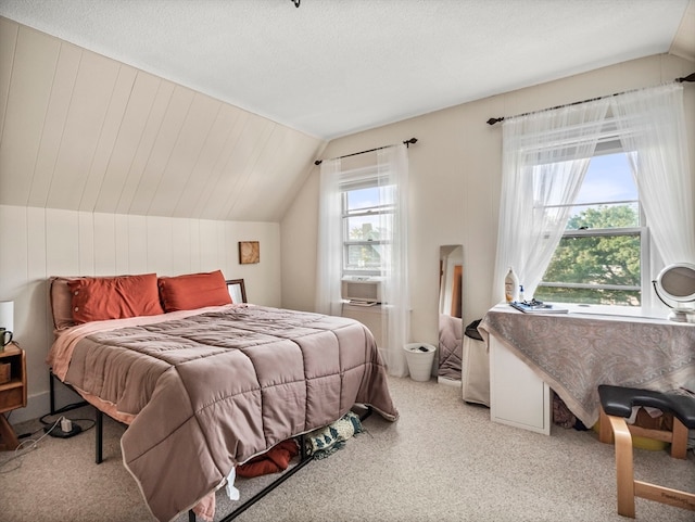 bedroom featuring a textured ceiling, lofted ceiling, and light carpet