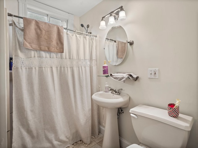 bathroom featuring walk in shower, tile patterned flooring, and toilet