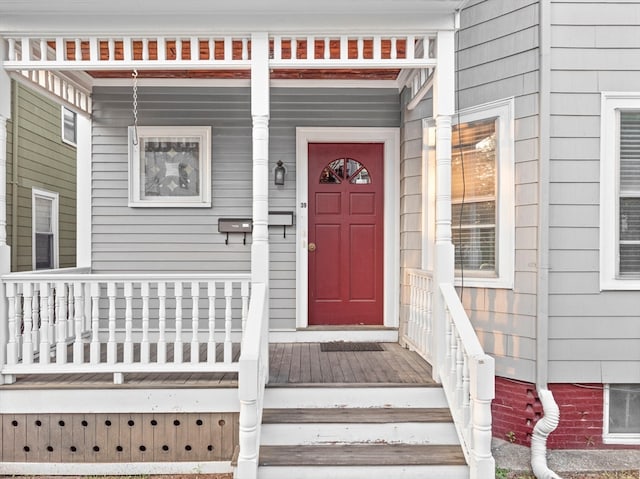 view of exterior entry with a porch