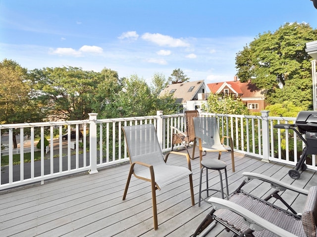 wooden terrace featuring a grill