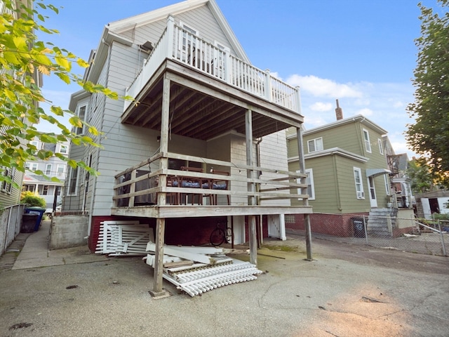 back of house with a wooden deck