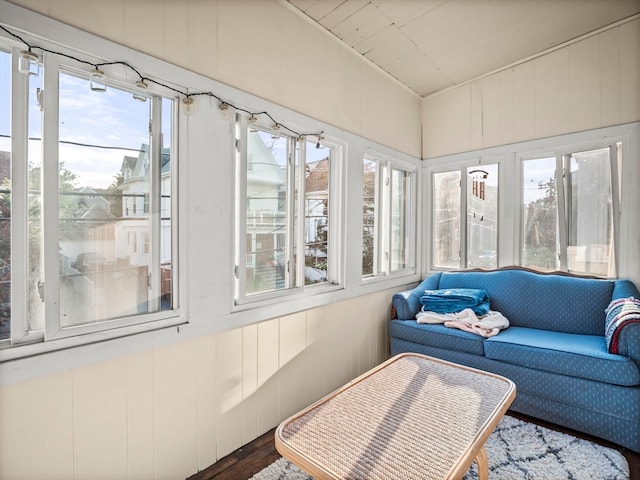 sunroom / solarium featuring lofted ceiling and plenty of natural light