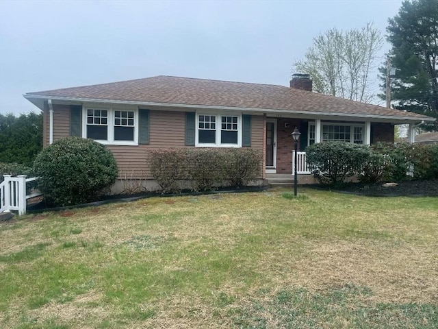 single story home with a chimney, a porch, and a front yard