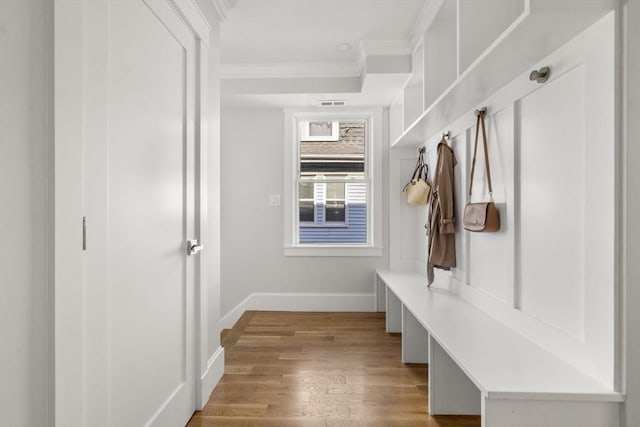 37-39 Governor Winthrop Rd, Somerville, MA 02145 - mudroom with baseboards, visible vents, ornamental molding, and wood finished floors
