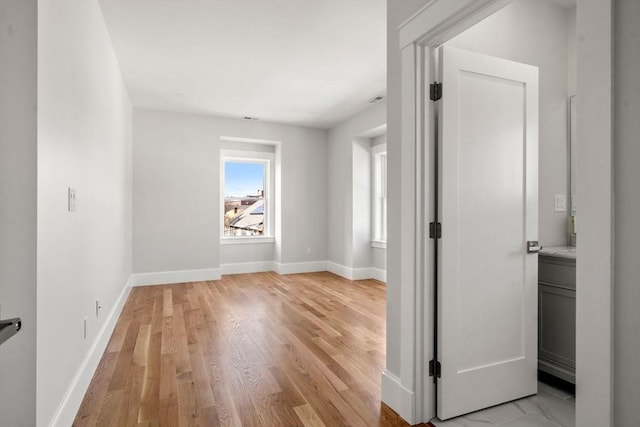37-39 Governor Winthrop Rd, Somerville, MA 02145 - empty room featuring baseboards and light wood-style flooring