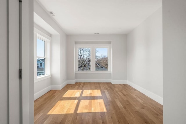 37-39 Governor Winthrop Rd, Somerville, MA 02145 - empty room with plenty of natural light, baseboards, and wood finished floors