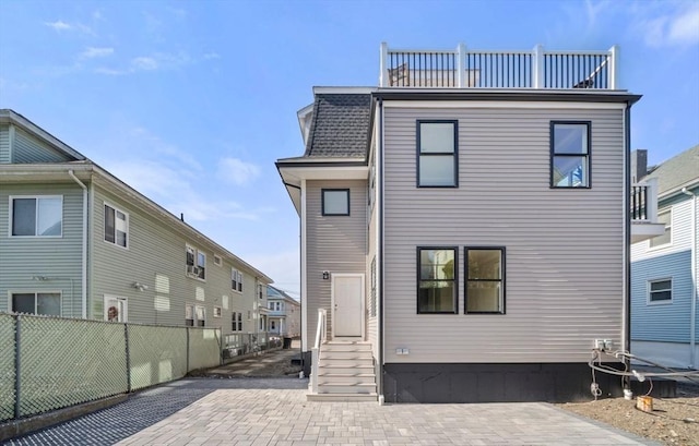 37-39 Governor Winthrop Rd, Somerville, MA 02145 - back of property featuring a patio, fence, a balcony, and entry steps