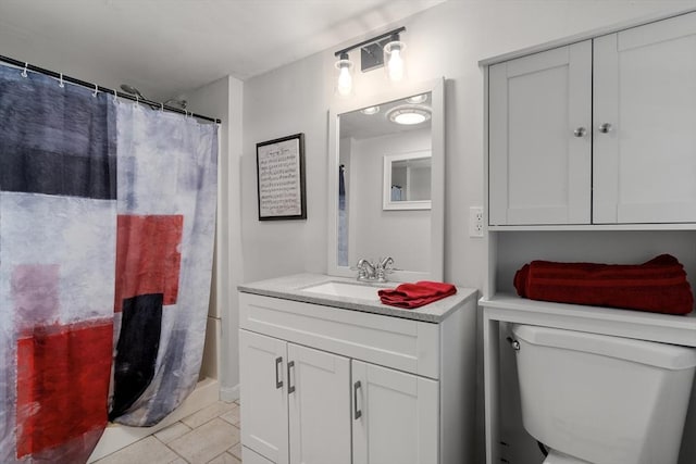 full bathroom featuring tile patterned floors, vanity, and toilet