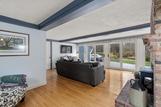 living room featuring crown molding, baseboards, baseboard heating, french doors, and light wood-style flooring