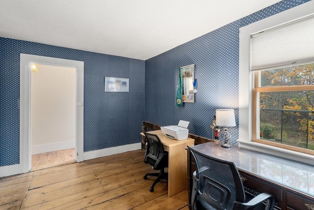 home office featuring baseboards, wood-type flooring, and wallpapered walls