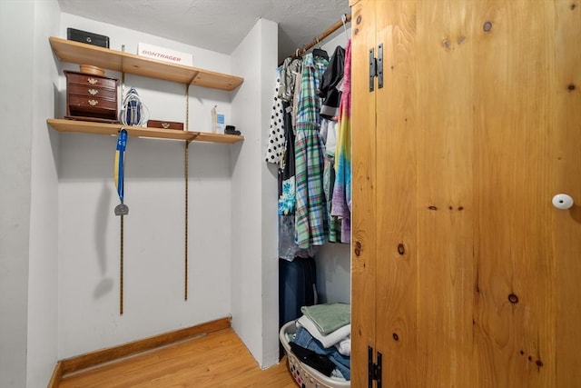 spacious closet featuring wood finished floors