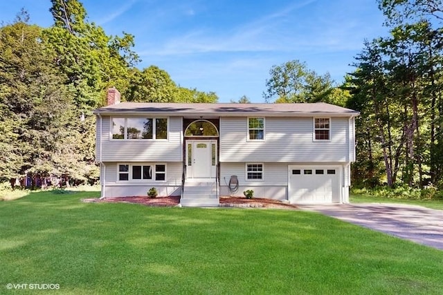 4 Gary Rd, Norton, MA 02766 - split foyer home with asphalt driveway, an attached garage, a chimney, and a front yard