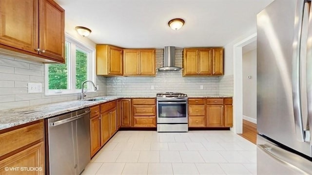 4 Gary Rd, Norton, MA 02766 - kitchen with stainless steel appliances, wall chimney exhaust hood, a sink, light stone counters, and brown cabinetry