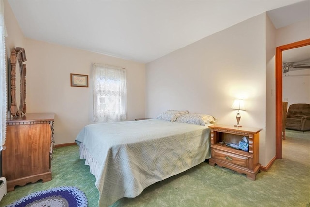 carpeted bedroom featuring a baseboard radiator