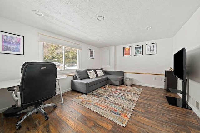 office area featuring recessed lighting, dark wood-style flooring, a textured ceiling, and baseboards