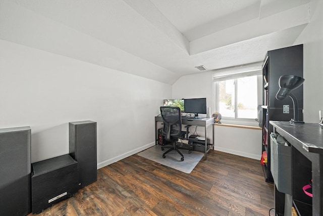 home office with lofted ceiling, visible vents, dark wood finished floors, and baseboards