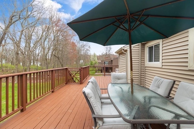 wooden terrace with outdoor dining space