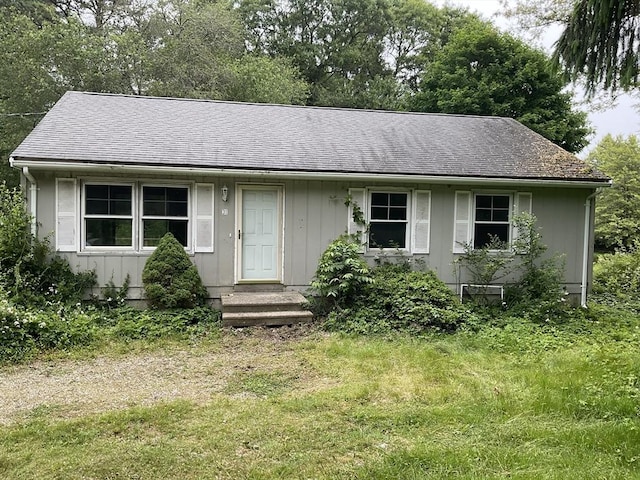 31 Main St, Mashpee, MA 02649 - view of front of house featuring board and batten siding, roof with shingles, and a front yard