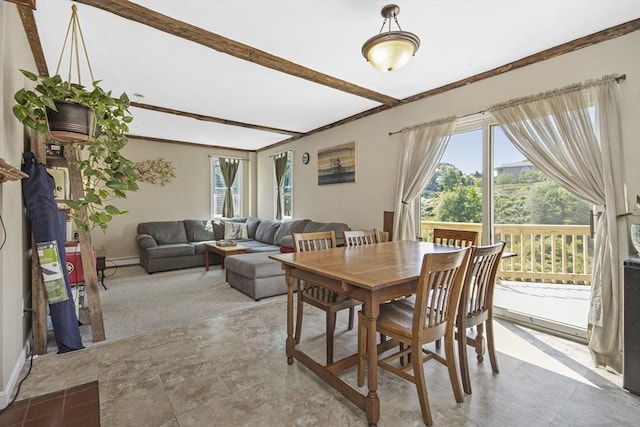 dining area with beamed ceiling, baseboards, and a baseboard heating unit