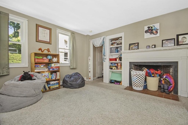 sitting room featuring a fireplace with flush hearth, carpet, and built in features