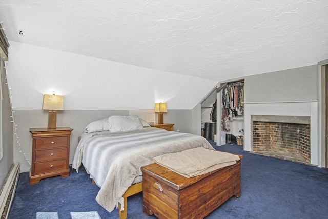 carpeted bedroom featuring a textured ceiling, vaulted ceiling, a closet, and a baseboard radiator