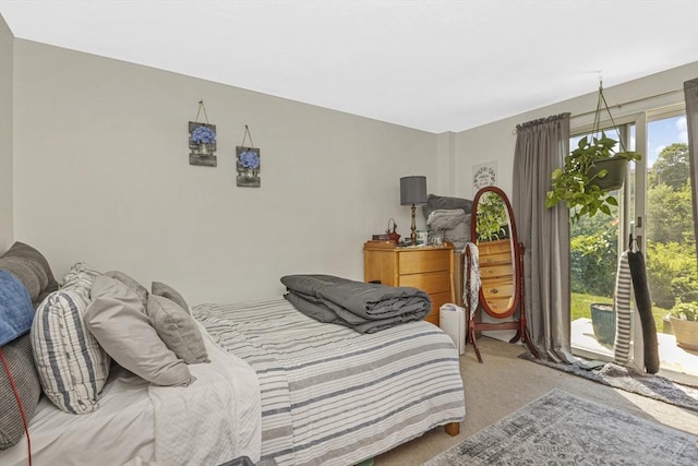 carpeted bedroom with access to outside