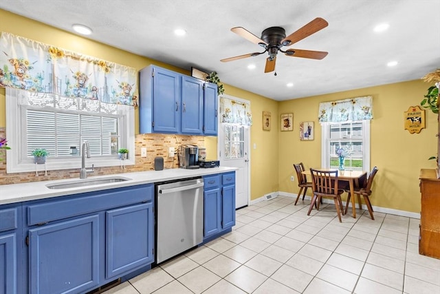 kitchen featuring a sink, light countertops, blue cabinetry, a ceiling fan, and stainless steel dishwasher