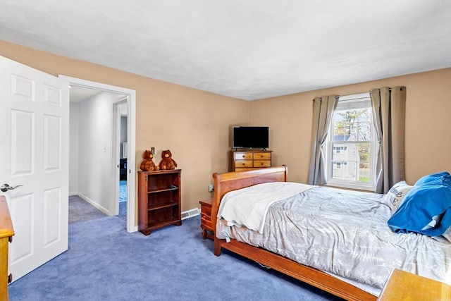 carpeted bedroom featuring baseboards