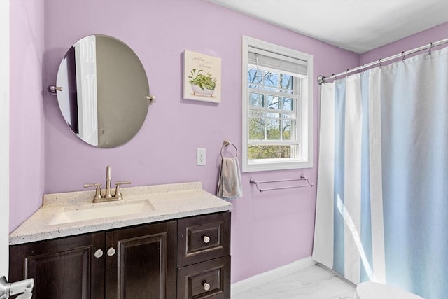 full bathroom with vanity, baseboards, and marble finish floor