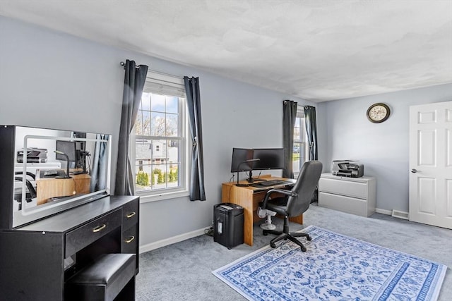 office space featuring baseboards, carpet flooring, and visible vents