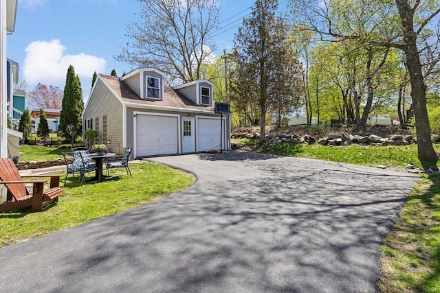 view of home's exterior with a lawn, driveway, and a garage