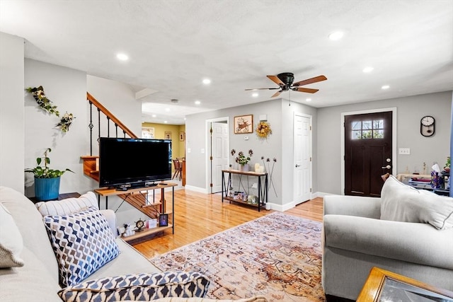 living area featuring stairs, recessed lighting, a ceiling fan, baseboards, and wood finished floors