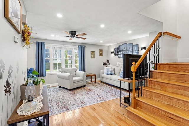 living room featuring baseboards, recessed lighting, stairs, and a ceiling fan