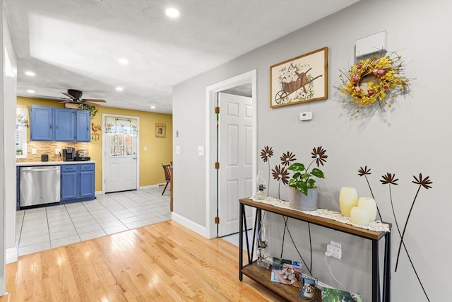 interior space with baseboards, light wood finished floors, and recessed lighting