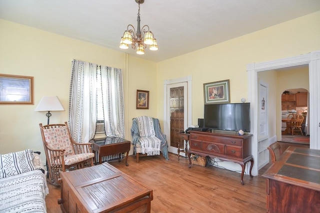 51 Garfield Ave, Revere, MA 02151 - living room featuring a chandelier, arched walkways, and wood finished floors