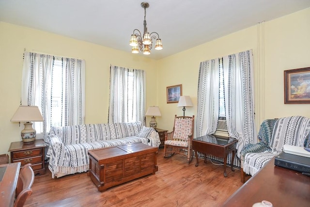 51 Garfield Ave, Revere, MA 02151 - living area featuring healthy amount of natural light, wood finished floors, and a chandelier