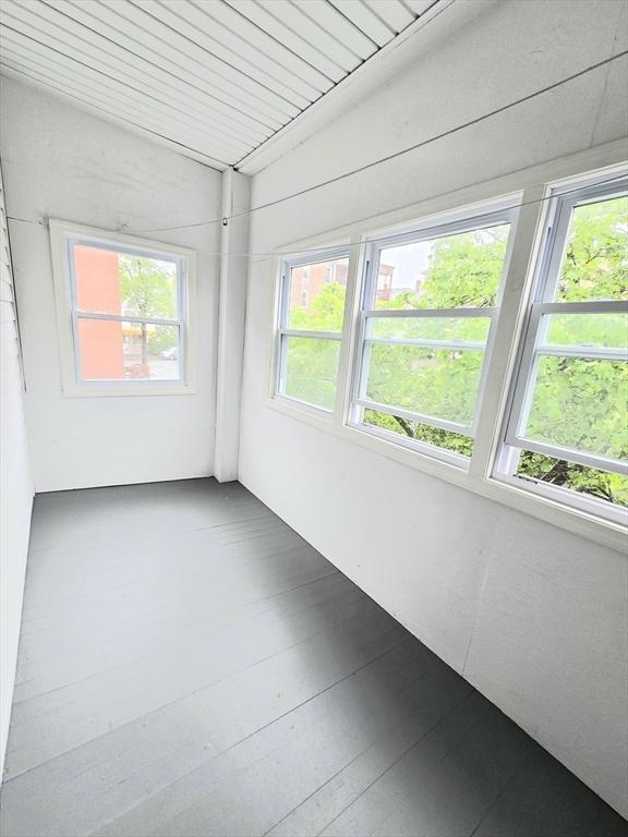 unfurnished sunroom featuring plenty of natural light