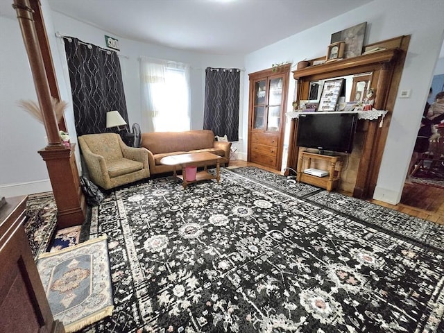 living area with wood finished floors and baseboards