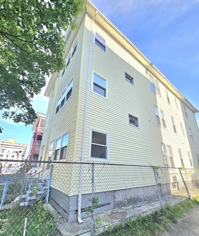 view of home's exterior featuring fence