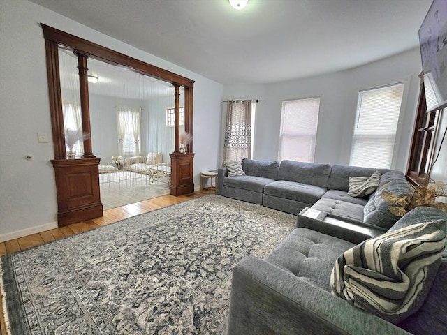 living area with hardwood / wood-style floors, healthy amount of natural light, and baseboards