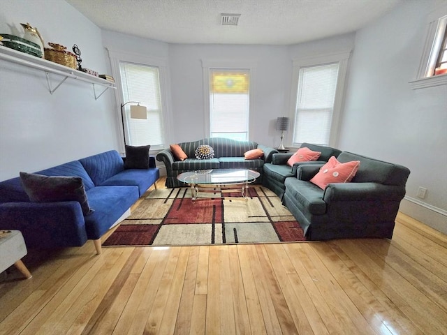 living area with hardwood / wood-style floors and healthy amount of natural light