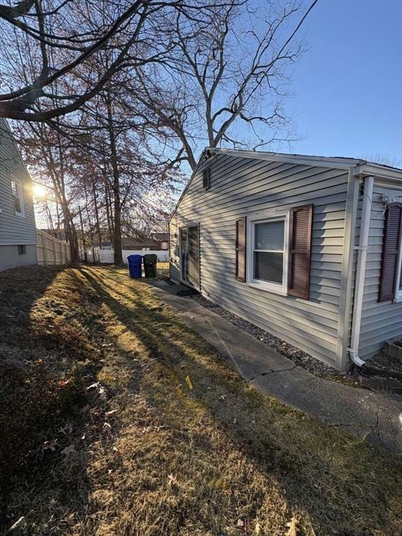 view of side of home featuring a lawn