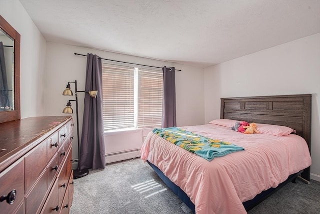 bedroom featuring a baseboard heating unit and light colored carpet